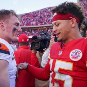 Denver Broncos quarterback Bo Nix (10) talks with Kansas City Chiefs quarterback Patrick Mahomes (15) after the game at GEHA Field at Arrowhead Stadium.