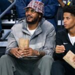 Carmelo Anthony and his son, Kiyan, watch the Don Bosco Prep Ironmen compete against the McEachern Indians in a game during the 50th annual City of Palms Classic at Suncoast Credit Union Arena in Fort Myers on Tuesday, Dec. 19, 2023. Kiyan Anthony and the Long Island Luthern Crusaders defeated Westminster Academy earlier in the day.