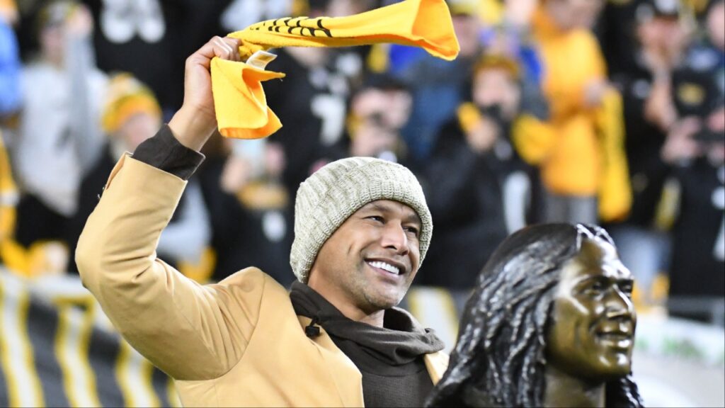 Pittsburgh Steelers former safety Troy Polamalu acknowledges fans during halftime against the Seattle Seahawks at Heinz Field. Polamalu was recognized for his induction into the Pro Football Hall of Fame.