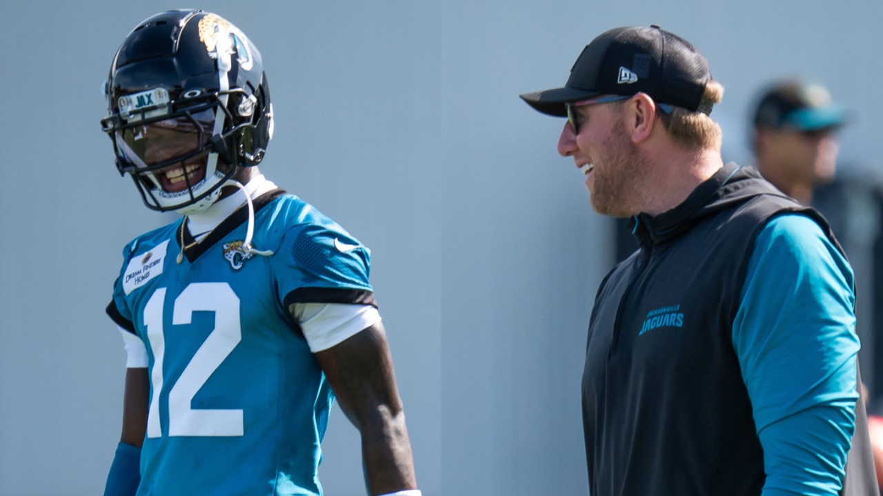 Jacksonville Jaguars wide receiver Travis Hunter (12) has a laugh with Jacksonville Jaguars head coach Liam Coen during the Jacksonville Jaguars’ third mandatory minicamp Thursday June 12, 2025 at the Miller Electric Center in Jacksonville, Fla. [Doug Engle/Florida Times-Union]