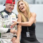 Jul 30, 2022; Speedway, Indiana, USA; NASCAR Xfinity Series driver AJ Allmendinger (16) and his wife Tara Meador have a laugh after winning the Penzoil 150 at the Indianapolis Motor Speedway Road Course