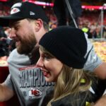 Recording artist Taylor Swift and Kansas City Chiefs tight end Travis Kelce (87) react after the AFC Championship game against the Buffalo Bills at GEHA Field at Arrowhead Stadium.