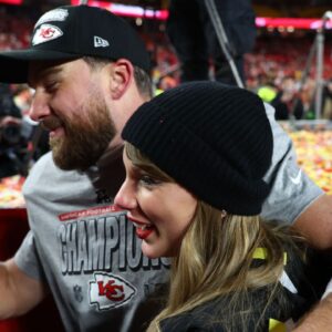 Recording artist Taylor Swift and Kansas City Chiefs tight end Travis Kelce (87) react after the AFC Championship game against the Buffalo Bills at GEHA Field at Arrowhead Stadium.