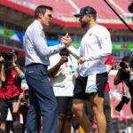 Fox NFL broadcaster and former NFL quarterback Tom Brady speaks to Tampa Bay Buccaneers quarterback Baker Mayfield (6) before a game against the Philadelphia Eagles at Raymond James Stadium.
