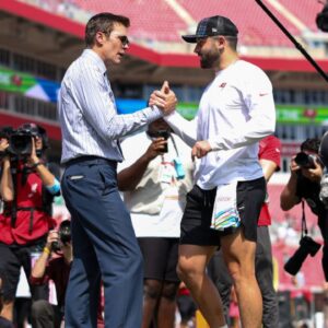 Fox NFL broadcaster and former NFL quarterback Tom Brady speaks to Tampa Bay Buccaneers quarterback Baker Mayfield (6) before a game against the Philadelphia Eagles at Raymond James Stadium.