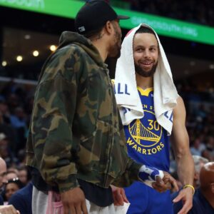 Apr 1, 2025; Memphis, Tennessee, USA; Golden State Warriors guard Stephen Curry (30) talks with guard Gary Payton II (0) during the second quarter against the Memphis Grizzlies at FedExForum.