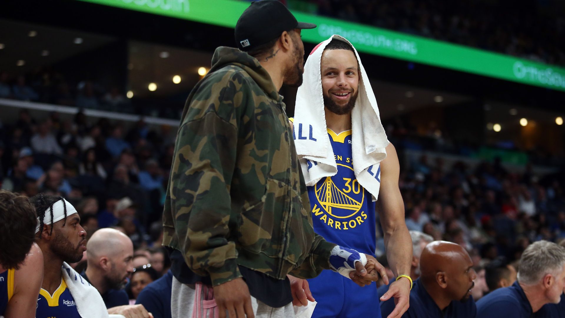 Apr 1, 2025; Memphis, Tennessee, USA; Golden State Warriors guard Stephen Curry (30) talks with guard Gary Payton II (0) during the second quarter against the Memphis Grizzlies at FedExForum.