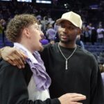May 16, 2025; San Francisco, California, USA; Golden State Warriors guard Brandin Podziemski (left) and Jonathan Kuminga (right) talk after the game between the Golden State Valkyries and the Los Angeles Sparks at Chase Center. Mandatory Credit: Darren Yamashita-Imagn Images