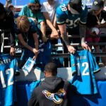 Jacksonville Jaguars wide receiver Travis Hunter (12) signs autographs before an NFL football matchup, Sunday, Oct. 12, 2025, at EverBank Stadium in Jacksonville, Fla. The Seahawks defeated the Jaguars 20-12.