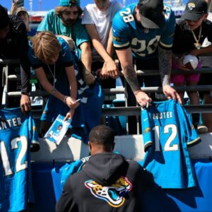 Jacksonville Jaguars wide receiver Travis Hunter (12) signs autographs before an NFL football matchup, Sunday, Oct. 12, 2025, at EverBank Stadium in Jacksonville, Fla. The Seahawks defeated the Jaguars 20-12.