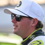 Sep 6, 2025; Madison, Illinois, USA; NASCAR Cup Series driver Noah Gragson (4) looks on during practice and qualifying for the Enjoy Illinois 300 at World Wide Technology Raceway