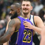 Feb 22, 2025; Denver, Colorado, USA; Denver Nuggets center Nikola Jokic (15) and Los Angeles Lakers forward LeBron James (23) hug before the game at Ball Arena