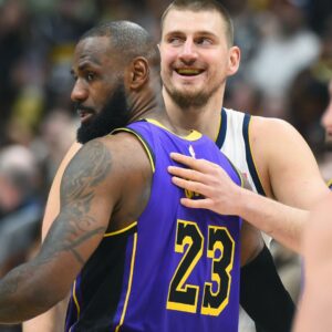 Feb 22, 2025; Denver, Colorado, USA; Denver Nuggets center Nikola Jokic (15) and Los Angeles Lakers forward LeBron James (23) hug before the game at Ball Arena