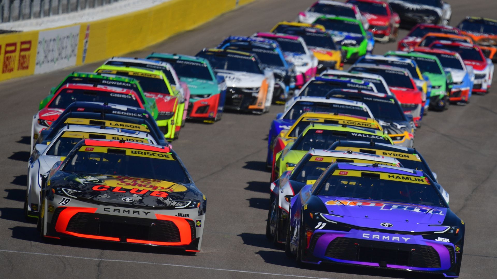 Oct 12, 2025; Las Vegas, Nevada, USA; NASCAR Cup Series driver Chase Briscoe (19) and driver Denny Hamlin (11) lead the field for the start of the South Point 400 at Las Vegas Motor Speedway.