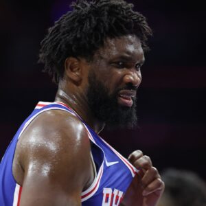 Oct 25, 2025; Philadelphia, Pennsylvania, USA; Philadelphia 76ers center Joel Embiid (21) reacts after being hit in the upper body during the third quarter against the Charlotte Hornets at Xfinity Mobile Arena.