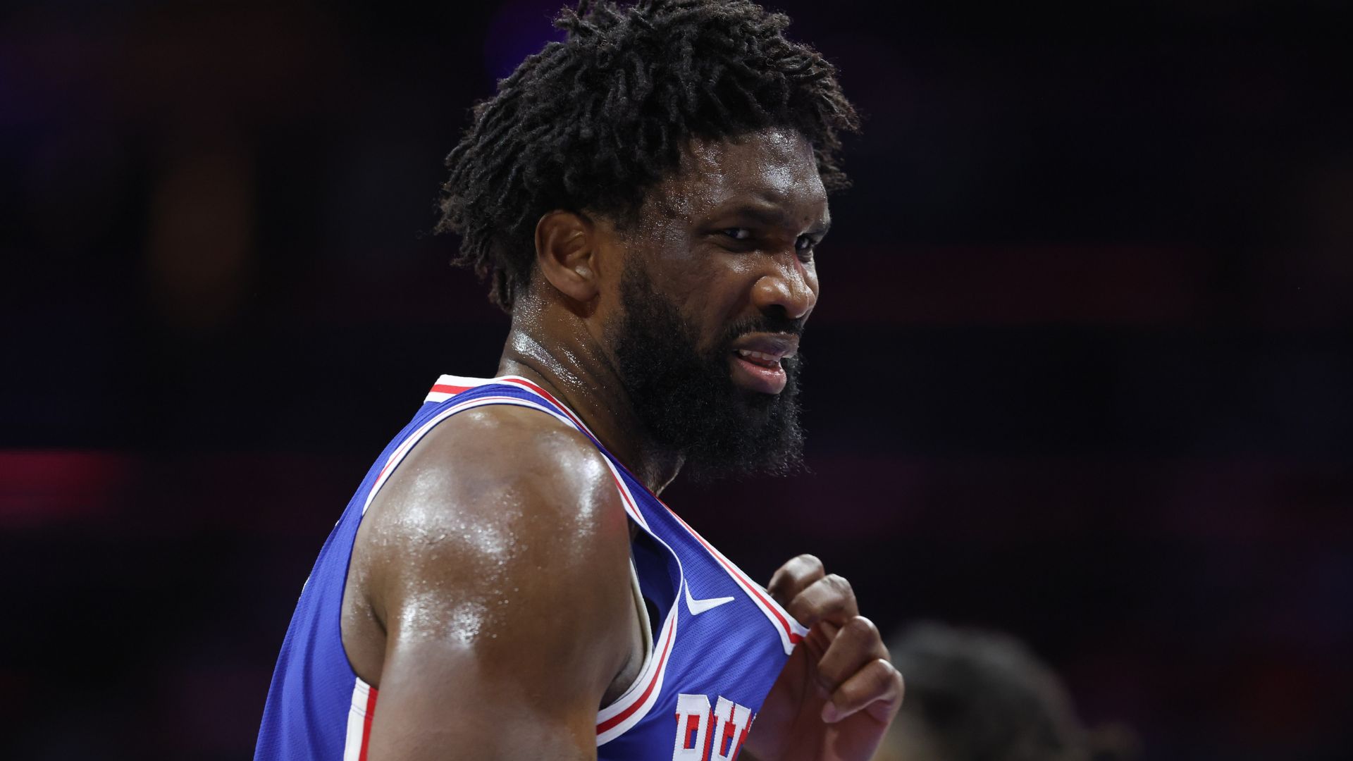 Oct 25, 2025; Philadelphia, Pennsylvania, USA; Philadelphia 76ers center Joel Embiid (21) reacts after being hit in the upper body during the third quarter against the Charlotte Hornets at Xfinity Mobile Arena.