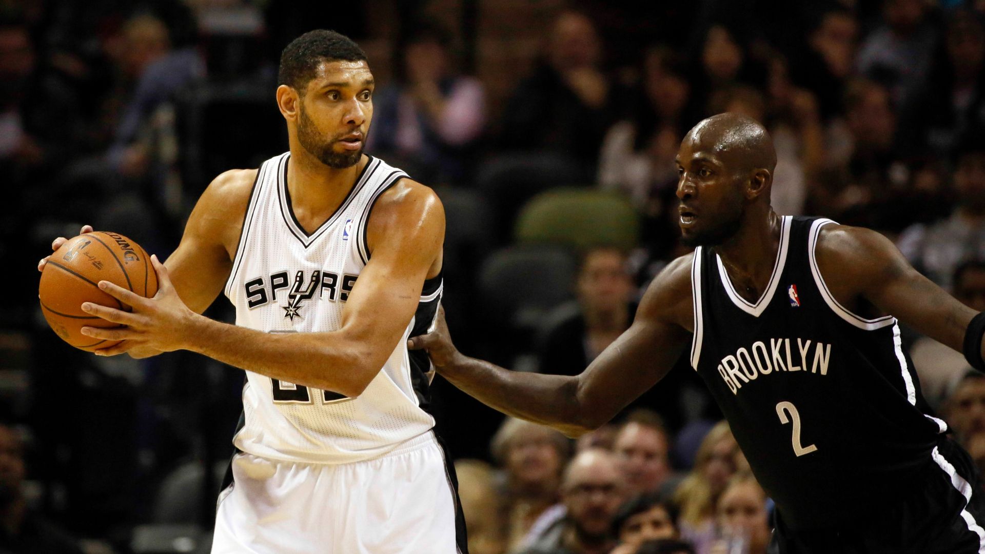 Dec 31, 2013; San Antonio, TX, USA; San Antonio Spurs forward Tim Duncan (left) is defended by Brooklyn Nets forward Kevin Garnett (2) during the first half at AT&T Center.