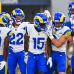 Los Angeles Rams wide receiver Konata Mumpfield (15) celebrates a touchdown with linebacker Byron Young (0), running back Blake Corum (22), and wide receiver Xavier Smith (19) against the Los Angeles Chargers during the first quarter at SoFi Stadium.