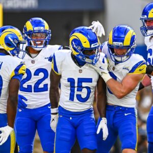 Los Angeles Rams wide receiver Konata Mumpfield (15) celebrates a touchdown with linebacker Byron Young (0), running back Blake Corum (22), and wide receiver Xavier Smith (19) against the Los Angeles Chargers during the first quarter at SoFi Stadium.