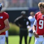 Minnesota Vikings quarterback J.J. McCarthy (9) and quarterback Sam Darnold (14) warm up during practice at Vikings training camp in Eagan, MN
