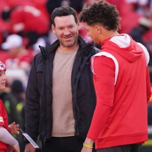 Dec 10, 2023; Kansas City, Missouri, USA; Kansas City Chiefs quarterback Patrick Mahomes (15) talks with former NFL quarterback and commentator Tony Romo and his sone Rivers prior to a game against the Buffalo Bills at GEHA Field at Arrowhead Stadium. Mandatory Credit: Denny Medley-Imagn Images