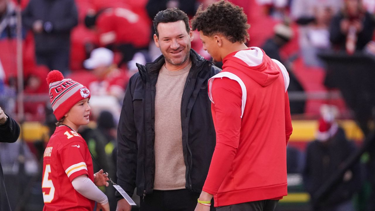 Dec 10, 2023; Kansas City, Missouri, USA; Kansas City Chiefs quarterback Patrick Mahomes (15) talks with former NFL quarterback and commentator Tony Romo and his sone Rivers prior to a game against the Buffalo Bills at GEHA Field at Arrowhead Stadium. Mandatory Credit: Denny Medley-Imagn Images