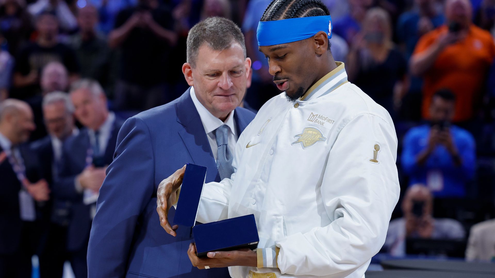 Oct 21, 2025; Oklahoma City, Oklahoma, USA; Oklahoma City Thunder guard Shai Gilgeous-Alexander looks at his championship ring during the ring ceremony before the start of their game against the Houston Rockets at Paycom Center.
