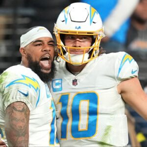 Los Angeles Chargers wide receiver Keenan Allen (13) celebrates with Los Angeles Chargers quarterback Justin Herbert (10) after scoring a touchdown against the Las Vegas Raiders during the second half at Allegiant Stadium.