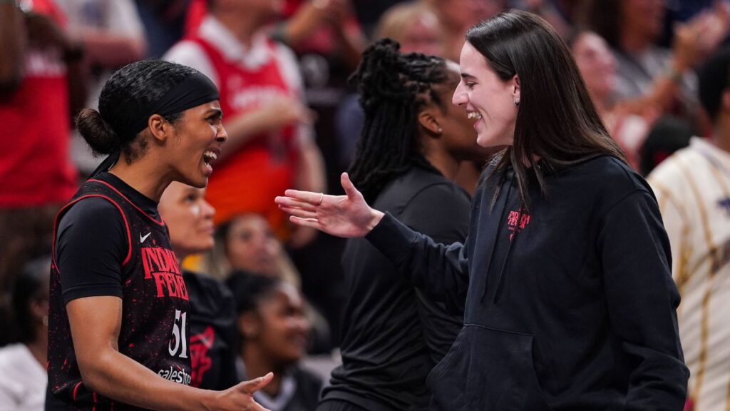 Indiana Fever guard Caitlin Clark (22) high-fives Indiana Fever guard Sydney Colson (51) on Thursday, July 24, 2025, during the game at Gainbridge Fieldhouse in Indianapolis.