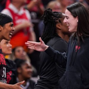 Indiana Fever guard Caitlin Clark (22) high-fives Indiana Fever guard Sydney Colson (51) on Thursday, July 24, 2025, during the game at Gainbridge Fieldhouse in Indianapolis.