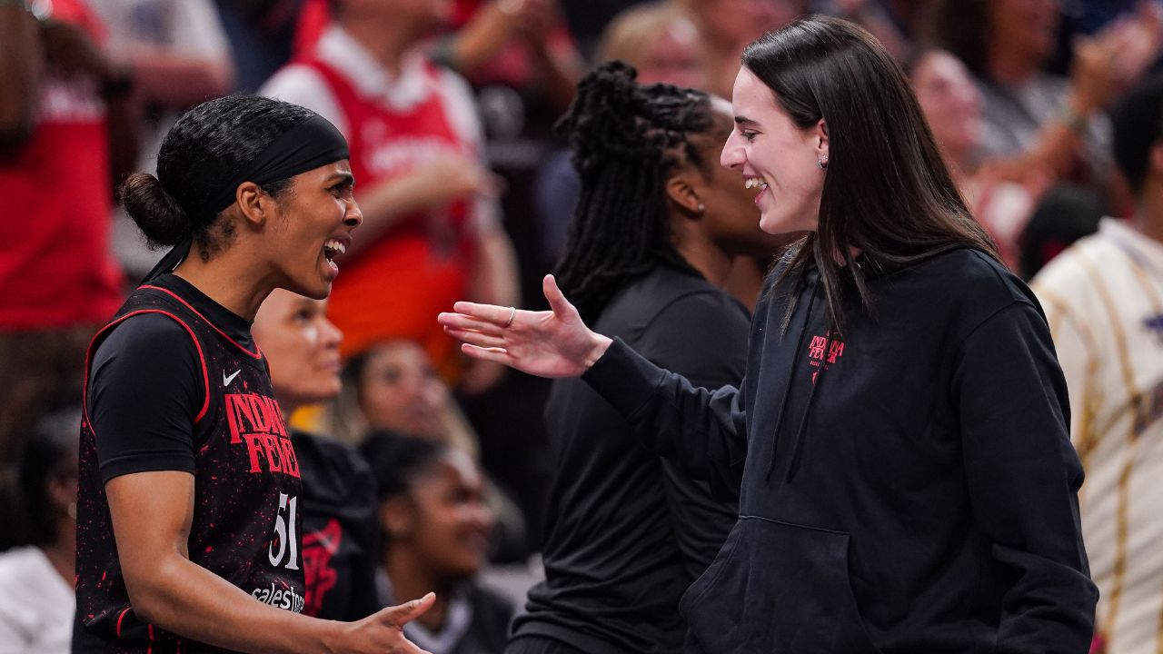 Indiana Fever guard Caitlin Clark (22) high-fives Indiana Fever guard Sydney Colson (51) on Thursday, July 24, 2025, during the game at Gainbridge Fieldhouse in Indianapolis.
