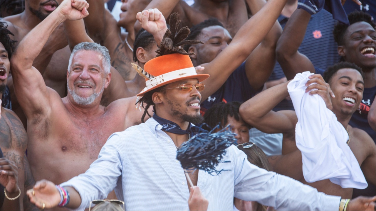 Auburn's mens basketball coach Bruce Pearl greets Auburn alum NFL quarterback Cam Newton at Jordan-Hare Stadium