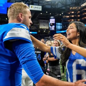 Detroit Lions quarterback Jared Goff hugs his wife Christen Harper during warmups before the Los Angeles Rams game at Ford Field in Detroit on Sunday, Sept. 8, 2024.