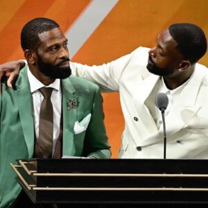 Aug 12, 2023; Springfield, MA, USA; Dwyane Wade (right) calls his father Dwyane Wade Sr. (left) onto the stage at his induction into the 2023 Basketball Hall of Fame at Symphony Hall. Mandatory Credit: Eric Canha-Imagn Images