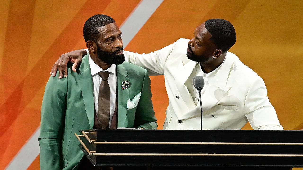 Aug 12, 2023; Springfield, MA, USA; Dwyane Wade (right) calls his father Dwyane Wade Sr. (left) onto the stage at his induction into the 2023 Basketball Hall of Fame at Symphony Hall. Mandatory Credit: Eric Canha-Imagn Images