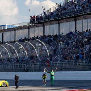 Apr 27, 2025; Talladega, Alabama, USA; NASCAR Cup Series driver Austin Cindric (2) waves the checkered flag for the fans after winning the NASCAR: Jack Link's 500 at Talladega Superspeedway