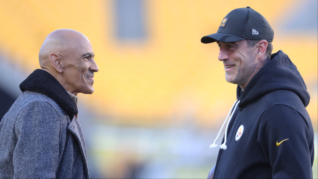 Professional Football Hall of Fame coach Tony Dungy (left) talks with Pittsburgh Steelers quarterback Aaron Rodgers (right) before the Steelers host the Green Bay Packers at Acrisure Stadium.