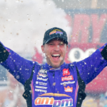 Oct 12, 2025; Las Vegas, Nevada, USA; NASCAR Cup Series driver Denny Hamlin (11) celebrates his victory following the South Point 400 at Las Vegas Motor Speedway. Mandatory Credit: Gary A. Vasquez-Imagn Images