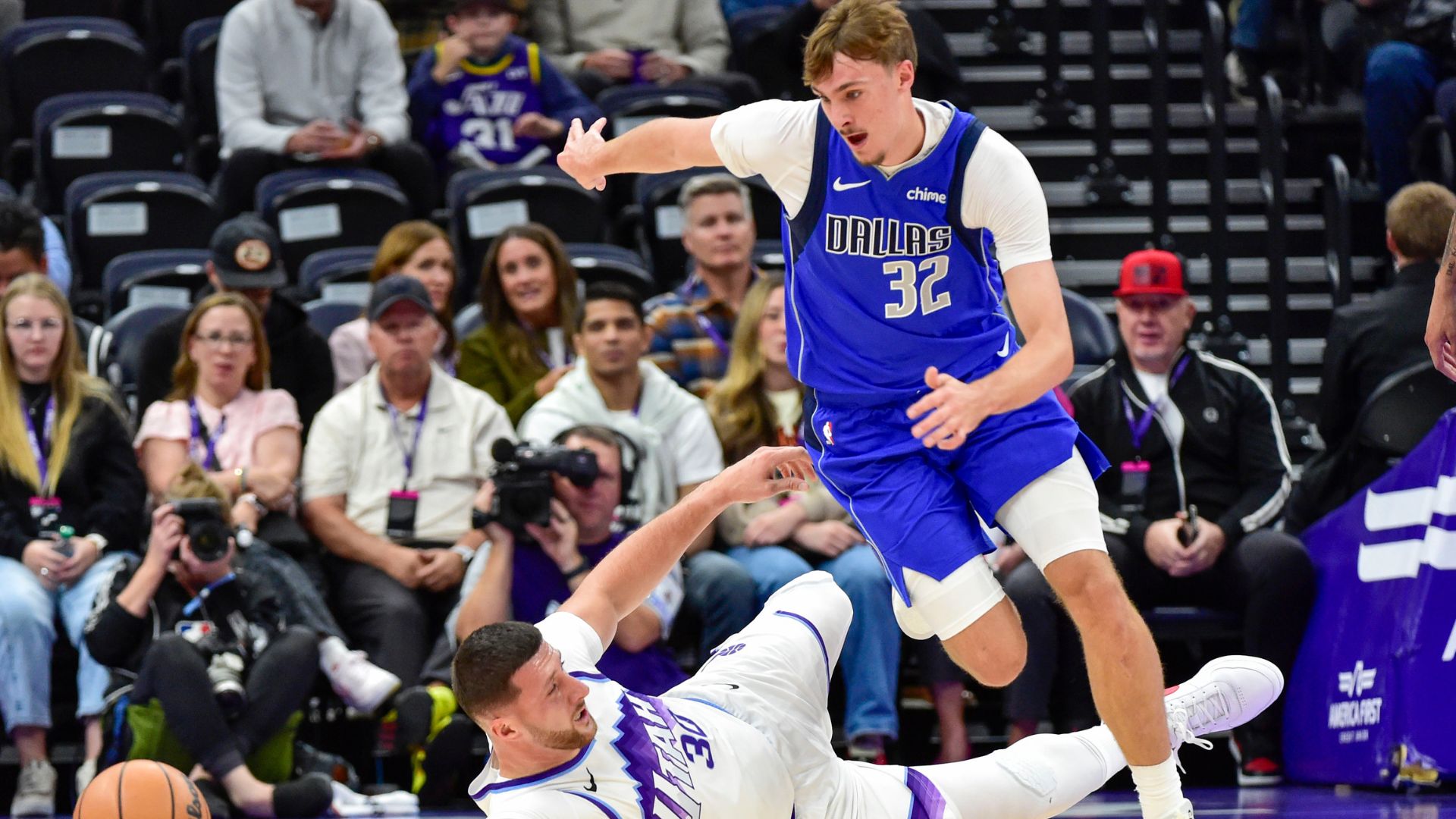 Oct 13, 2025; Salt Lake City, Utah, USA; Utah Jazz center Jusuf Nurkić (30) slides for the ball against Dallas Mavericks forward Cooper Flagg (32) during the first quarter at Delta Center.