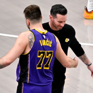 Apr 9, 2025; Dallas, Texas, USA; Los Angeles Lakers head coach JJ Redick and guard Luka Doncic (77) during the game between the Dallas Mavericks and the Los Angeles Lakers at American Airlines Center.