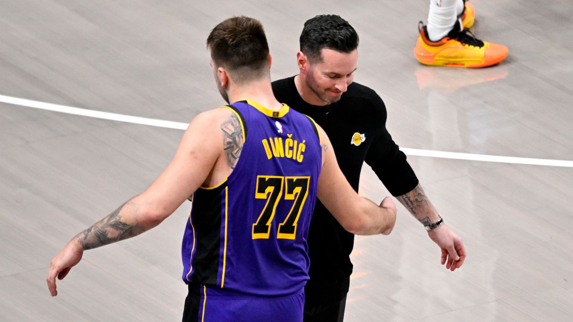 Apr 9, 2025; Dallas, Texas, USA; Los Angeles Lakers head coach JJ Redick and guard Luka Doncic (77) during the game between the Dallas Mavericks and the Los Angeles Lakers at American Airlines Center.