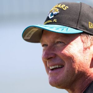 Former NFL Coach Jon Gruden have a laugh while attending an NFL training camp session ten at the Miller Electric Center, Tuesday, Aug. 5, 2025, in Jacksonville, Fla.