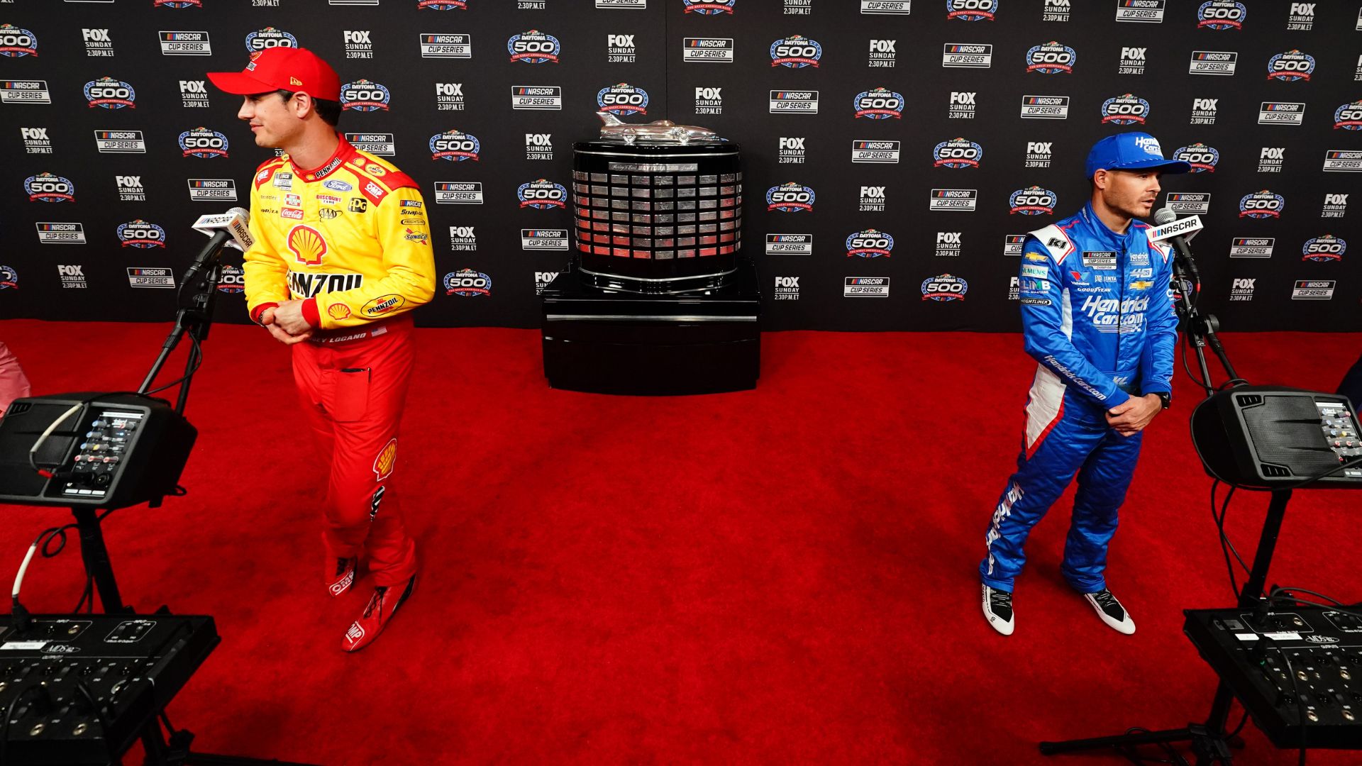 Feb 14, 2024; Daytona Beach, Florida, USA; NASCAR Cup Series driver Joey Logano (22) and driver Kyle Larson (5) speaks with reporters during media day at Daytona International Speedway