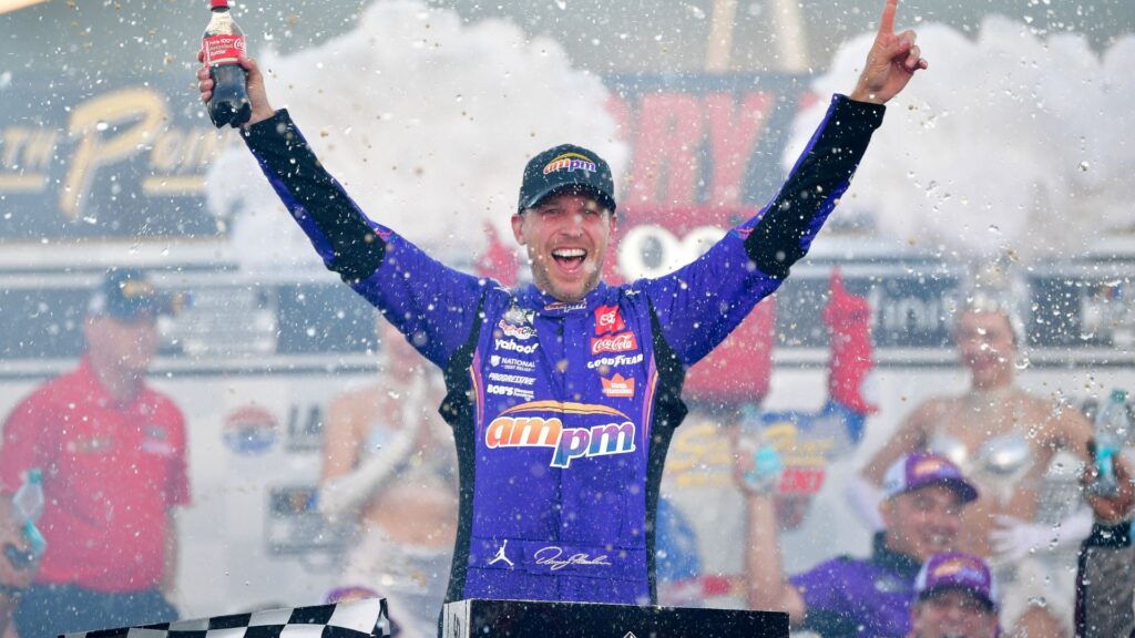 Oct 12, 2025; Las Vegas, Nevada, USA; NASCAR Cup Series driver Denny Hamlin (11) celebrates his victory following the South Point 400 at Las Vegas Motor Speedway