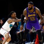 Mar 29, 2025; Memphis, Tennessee, USA; Los Angeles Lakers forward LeBron James (23) dribbles as Memphis Grizzlies guard Ja Morant (12) defends during the third quarter at FedExForum.