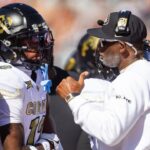 Colorado Buffalos wide receiver Travis Hunter (12) with head coach Deion Sanders against the Arizona Wildcats at Arizona Stadium.