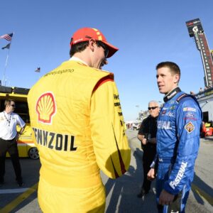Feb 19, 2014; Daytona Beach, FL, USA; NASCAR Sprint Cup driver Joey Logano (22) talks with NASCAR Sprint Cup driver Dale Earnhardt Jr (88) during practice for the Daytona 500 at Daytona International Speedway.
