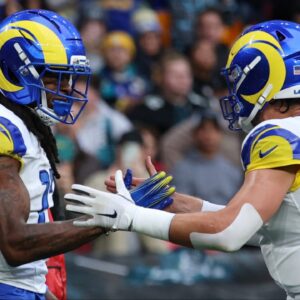 Los Angeles Rams wide receiver Davante Adams (17) celebrates with quarterback Matthew Stafford (9) after scoring a touchdown against the Jacksonville Jaguars during the first half during a NFL International Series game at Wembley Stadium.