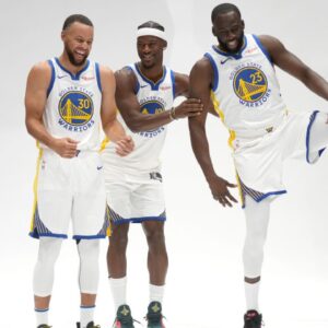 Golden State Warriors guard Stephen Curry (30), forward Draymond Green (23), and forward Jimmy Butler III (10) prepare to pose for a photo during Media Day at the Chase Center.