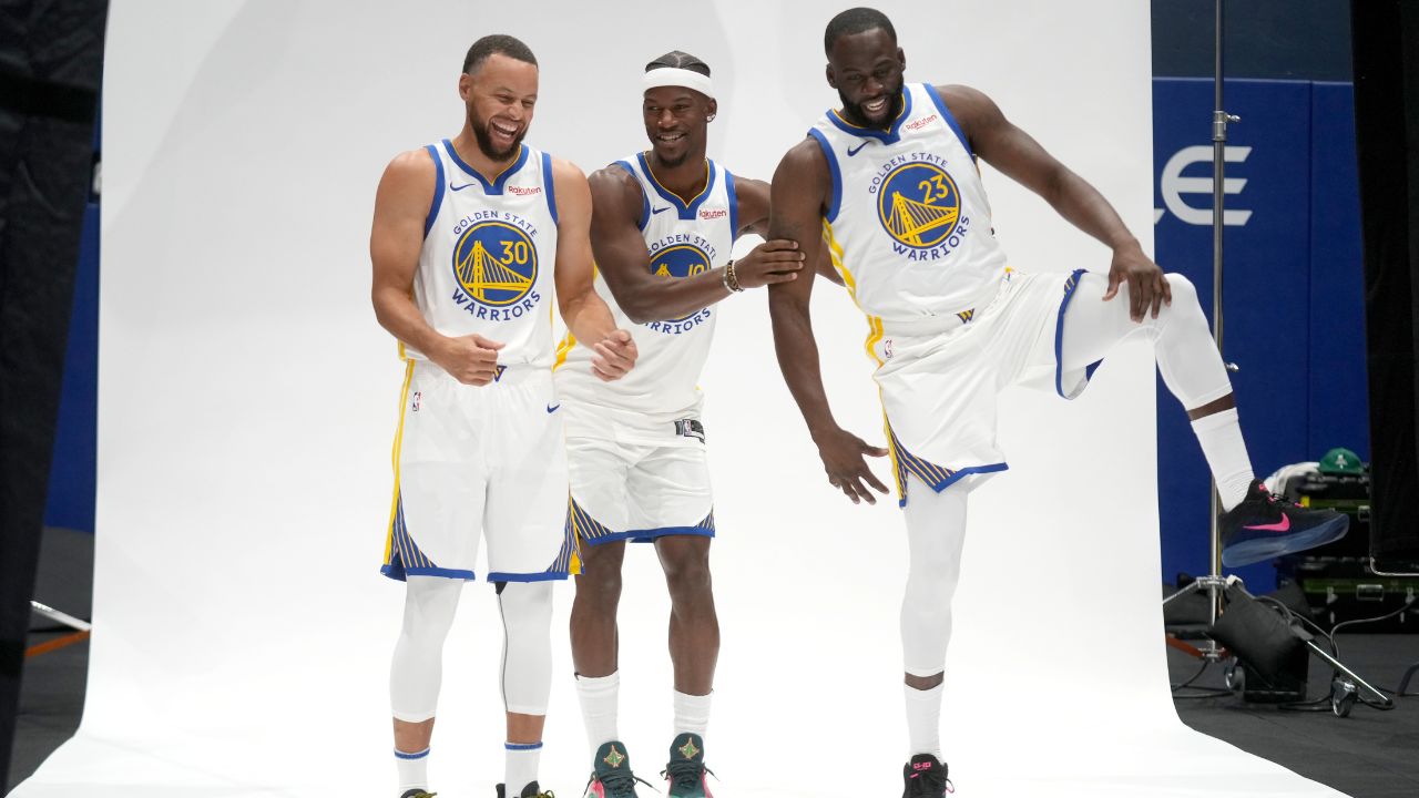 Golden State Warriors guard Stephen Curry (30), forward Draymond Green (23), and forward Jimmy Butler III (10) prepare to pose for a photo during Media Day at the Chase Center.